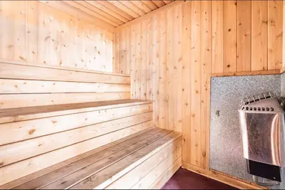 a sauna with wooden paneling and a stove at Mammoth Ski and Racquet 89 in Mammoth Lakes