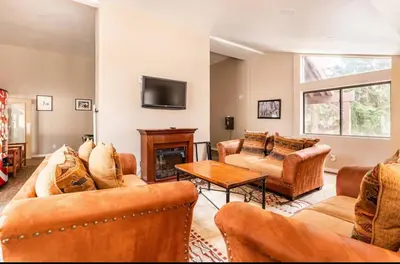 a living room with leather furniture and a fireplace at Mammoth Ski and Racquet 89 in Mammoth Lakes