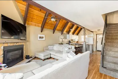 a living room with a white couch and a fireplace at Mammoth View Villas 32 in Mammoth Lakes