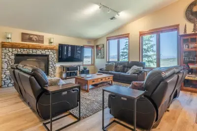 a living room with leather furniture and a fireplace at Snowcreek 821 in Mammoth Lakes