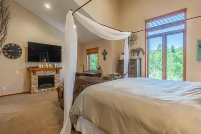 a bedroom with a bed and a fireplace at Snowcreek 821 in Mammoth Lakes