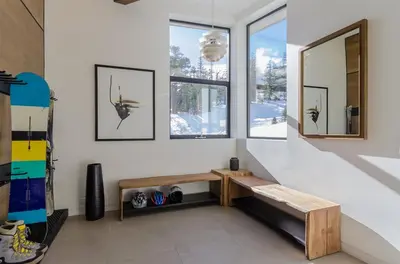 a living room with a bench and two windows at 88 Bridges Lane in Mammoth Lakes