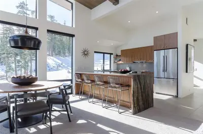 a kitchen with a table and chairs and a refrigerator at 88 Bridges Lane in Mammoth Lakes