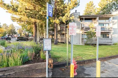 a red fire hydrant in a street with signs at Sierra Park Villas 45 in Mammoth Lakes