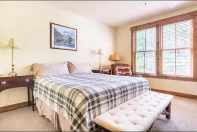 a bedroom with a bed and a desk and window at Lodges 1129 in Mammoth Lakes