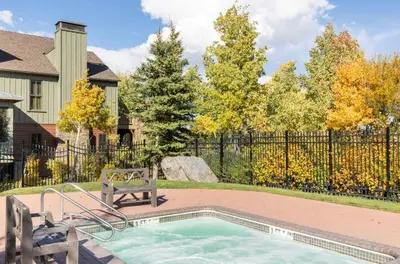 a swimming pool with a bench and a fence at Lodges 1129 in Mammoth Lakes