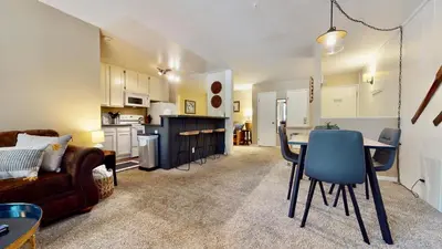 a living room and kitchen with a table and a couch at Crestview 45 in Mammoth Lakes