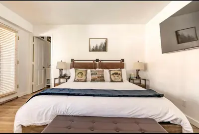 a bedroom with a large bed and two lamps at Forest Creek 21 in Mammoth Lakes