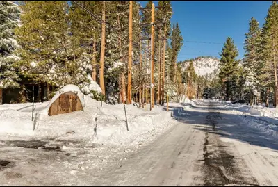 a snow covered road with a tent on the side at Forest Creek 21 in Mammoth Lakes