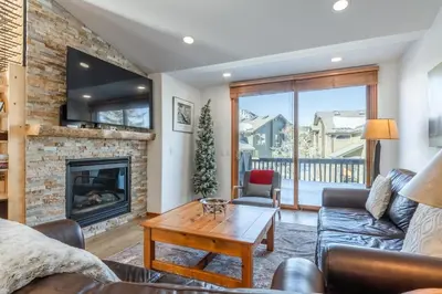 a living room with a couch and a fireplace at Snowcreek 778 in Mammoth Lakes