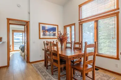 a dining room with a wooden table and chairs at Snowcreek 778 in Mammoth Lakes