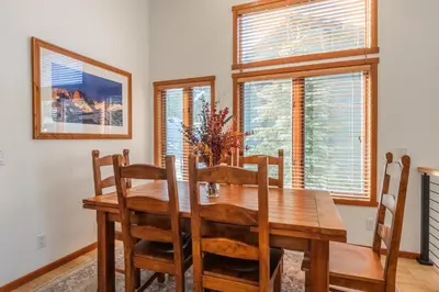 a dining room with a wooden table and chairs at Snowcreek 778 in Mammoth Lakes
