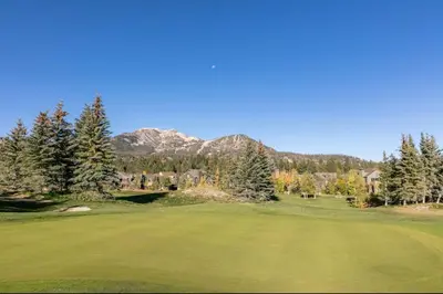 a view of a golf course with mountains in the background at Snowcreek 778 in Mammoth Lakes