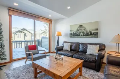 a living room with a couch and a table at Snowcreek 778 in Mammoth Lakes