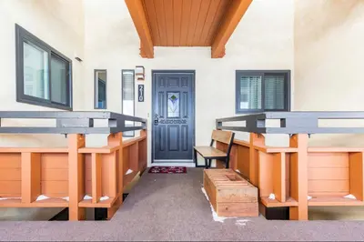 a room with two benches and a blue door at Bridges 210 in Mammoth Lakes