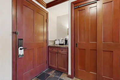 a room with a door and a kitchen with a counter at Everline Resort & Spa 536 in Olympic Valley