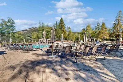 a group of chairs and umbrellas next to a pool at Everline Resort & Spa 536 in Olympic Valley