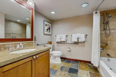 a bathroom with a sink and a toilet and a tub at Everline Resort & Spa 534 in Olympic Valley