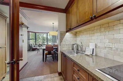 a kitchen with a sink and a dining room at Everline Resort & Spa 534 in Olympic Valley