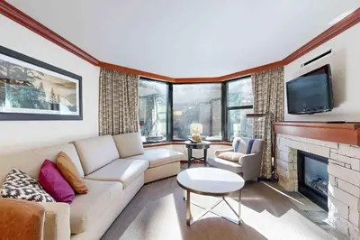a living room with a couch and a fireplace at Everline Resort & Spa 534 & 536 in Olympic Valley