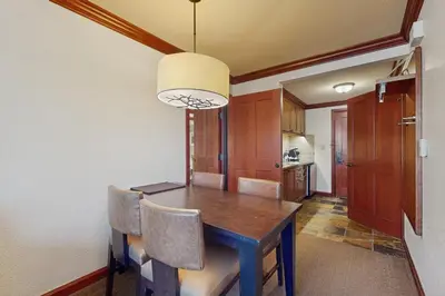 a dining room with a wooden table and chairs at Everline Resort & Spa 534 & 536 in Olympic Valley