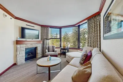 a living room with a couch and a fireplace at Everline Resort & Spa 534 & 536 in Olympic Valley