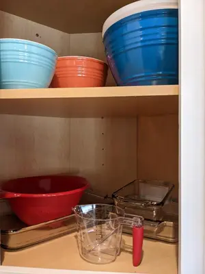 a shelf with bowls and other dishes on it at 717 Charming 4 Bed Mid-Town Retreat in Reno