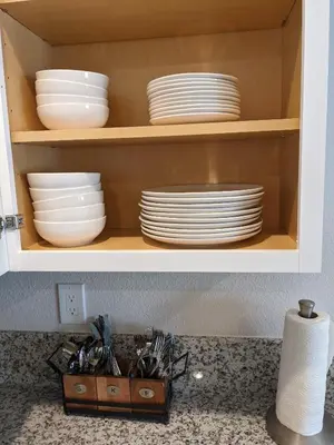 a cabinet filled with plates and bowls and dishes at 717 Charming 4 Bed Mid-Town Retreat in Reno