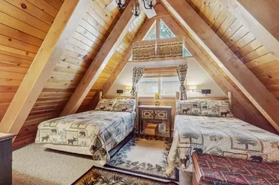 a bedroom with two beds in a attic at Cabin on Ralph in South Lake Tahoe