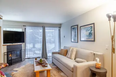 a living room with a couch and a fireplace at Ski In Canyon Lodge Modern 1 bdrm Pacman and Garage in Mammoth Lakes