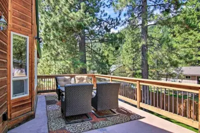 a deck with two chairs on a porch with trees at The Salty Pine - Pool Table, Small Dogs, 4 Bedrms in South Lake Tahoe