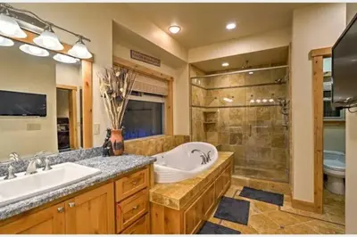 a bathroom with a tub and a sink and a shower at The Salty Pine - Pool Table, Small Dogs, 4 Bedrms in South Lake Tahoe
