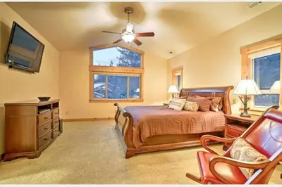 a bedroom with a bed and a ceiling fan at The Salty Pine - Pool Table, Small Dogs, 4 Bedrms in South Lake Tahoe
