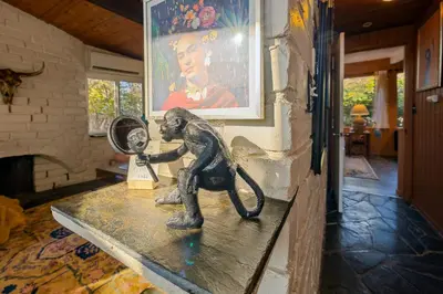 a statue of a monkey looking in a mirror at 16 mi to Yosemite-1 mi to Oakhurst-Anthro Decor in Oakhurst