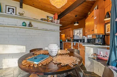 a kitchen with a table with a cake on it at 16 mi to Yosemite-1 mi to Oakhurst-Anthro Decor in Oakhurst