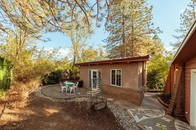 a small shed with a table in a yard at 16 mi to Yosemite - Rustic Studio - Hiking Nearby in Oakhurst