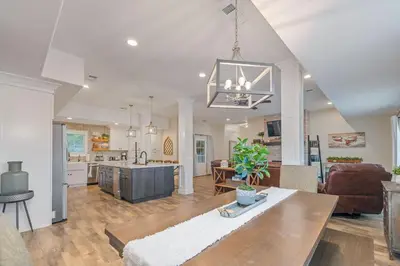 a kitchen and living room with a table and a couch at Lake View Private Dock 18 miles to Yosemite in Bass Lake
