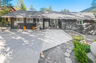 a house with a driveway in front of it at Lake View Private Dock 18 miles to Yosemite in Bass Lake