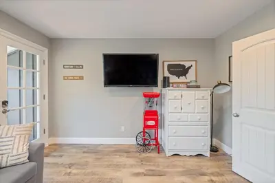 a living room with a flat screen tv on a wall at Lake View Private Dock 18 miles to Yosemite in Bass Lake