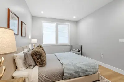 a bedroom with a bed and a chair in it at Tahoe Toasty - 3 Bedroom Home Near Sledding Hill in South Lake Tahoe