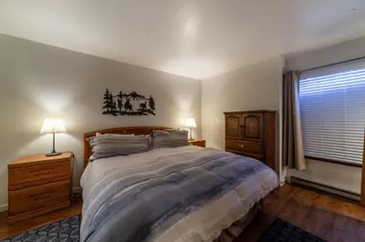 a bedroom with a large bed and a window at Adventure by Day Cozy Nights Family Alpine Condo in Mammoth Lakes