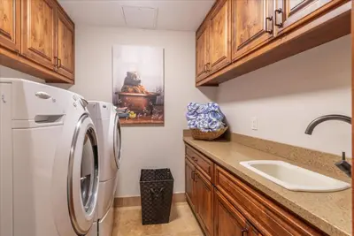 a kitchen with a white refrigerator and a sink at 2 Luxury Adjacent Northstar Homes Walk to Lifts Private Hot Tubs in Truckee