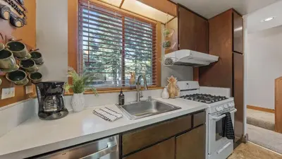 a kitchen with a sink and a stove at Unique Northstar Cabin w Fireplace Minutes to Skiing Trails and Town Alpine Bend by AvantStay in Truckee