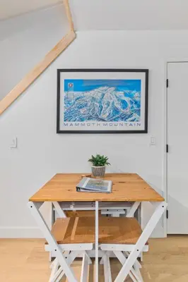 a table in a room with a picture on the wall at Stylish Mammoth 1BR & Loft With Fireplace in Mammoth Lakes