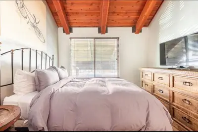 a bedroom with a bed with a television and a dresser at Val DIsere 27 in Mammoth Lakes