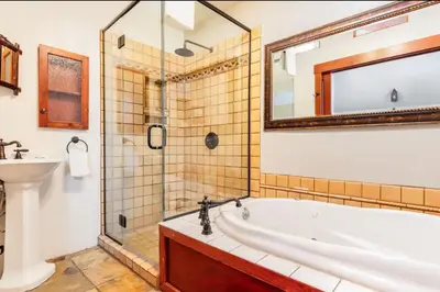 a bathroom with a tub and a sink at Val DIsere 27 in Mammoth Lakes