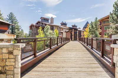 a wooden walkway leading to a resort building at Val DIsere 27 in Mammoth Lakes
