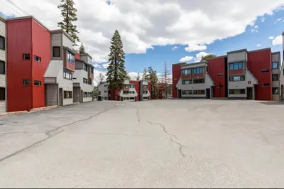 an empty parking lot in front of some buildings at Treehouse at Canyon Lodge Walk to Slopes in Mammoth Lakes