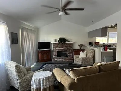 a living room with a couch and a fireplace at Turlocks Little Palace in Turlock
