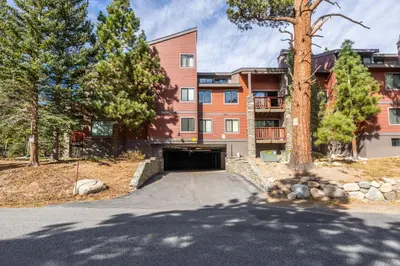 a building with a garage in front of a building at Summit 107 in Mammoth Lakes
